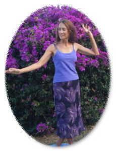 Deva doing kundalini mudra dance Deva doing Tantra Goddess Kundalini dance near purple flowers on Maui